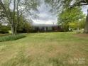 Charming one-story brick home featuring a well-manicured front lawn and mature trees at 1620 Moss Springs Rd, Albemarle, NC 28001