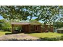 Charming brick home featuring a covered parking area and well-maintained front lawn at 1684 Montevista Dr, Shelby, NC 28150