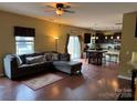 Open-concept living area with hardwood floors, access to the kitchen, and natural light at 1905 Yellow Daisy Dr, Matthews, NC 28104