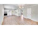 Open kitchen with white cabinets, modern appliances, and new vinyl flooring for a fresh look at 218 Valleybrook Ln, Troutman, NC 28166