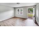 Bright living room featuring new vinyl floors and an open door with views of the front yard at 218 Valleybrook Ln, Troutman, NC 28166