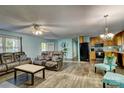 Cozy living room showcasing hardwood floors, and comfortable seating adjacent to the open-concept kitchen at 221 Delview Dr, Cherryville, NC 28021