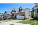 Lovely home with a two-car garage, featuring well-kept landscaping and an American flag, showcasing curb appeal at 2333 Talon Point Cir, Fort Mill, SC 29715