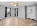Inviting living room featuring new floors, neutral paint, and an elegant front door at 268 Jefferson Ne Ct, Concord, NC 28025