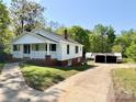 Quaint two-story house with a welcoming porch and convenient driveway at 2724 Peachtree Rd, Statesville, NC 28625