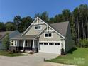 Inviting home with a two-car garage, stone accents, and lush landscaping, perfect for families at 3022 Cedar Falls Dr # 16, Waxhaw, NC 28173