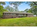 Charming brick home with a covered front porch, well-manicured lawn, and mature trees at 3378 Tanglewood Dr, Rock Hill, SC 29732