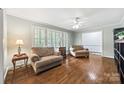 Cozy living room with hardwood floors, neutral paint, ceiling fan, and window shutters at 3378 Tanglewood Dr, Rock Hill, SC 29732