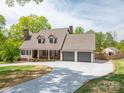 Inviting home featuring a brick-accented porch, two-car garage, and long driveway at 3755 11Th Ne St, Hickory, NC 28601