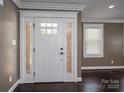 Elegant white front door with sidelights and transom window, leading into a beautifully finished home at 3755 11Th Ne St, Hickory, NC 28601