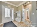 Inviting foyer with wood floors, coat rack and storage, and front door with decorative glass at 4083 Home Grown Way, Clover, SC 29710