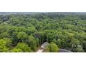 An aerial perspective of a house surrounded by dense green forest at 409 Woodcrest Ln, Albemarle, NC 28001