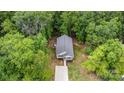 Aerial view of a quaint home nestled amidst lush green trees at 409 Woodcrest Ln, Albemarle, NC 28001