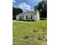Well-maintained single-story home with lush front lawn, offering a serene and inviting atmosphere at 5012 Wheat Sw Dr, Concord, NC 28027