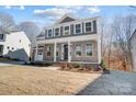 Charming new construction home with brick facade, covered porch, and manicured front yard at 5027 Mclaughlin Loop # 61, Waxhaw, NC 28173