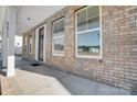 Inviting front porch with brick accents, a black front door, and large windows at 5027 Mclaughlin Loop # 61, Waxhaw, NC 28173