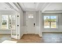 Bright foyer showcasing a paneled front door, classic trim, wood flooring, and a view to a bright office at 5031 Mclaughlin Loop # 60, Waxhaw, NC 28173