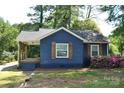 Charming blue home featuring a covered porch with wooden columns and shutters at 510 Belmont Mount Holly Rd, Belmont, NC 28012