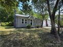 Charming single-Gathering home with gray siding and a brick chimney at 589 Fork Rd, Norwood, NC 28128