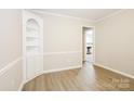 Bright living room features fresh paint, wood trim, built-in shelves and laminate flooring at 721 Summerwood Dr, Rock Hill, SC 29732