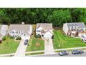 Aerial view of a suburban home with a well-maintained lawn and a two-car garage at 8800 Darcy Hopkins Dr, Charlotte, NC 28277