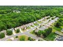 Aerial shot of a residential area with lush trees surrounding a neighborhood and its streets at 8800 Darcy Hopkins Dr, Charlotte, NC 28277