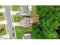 Aerial view of a suburban neighborhood showcasing neat lawns and proximity to lush trees at 8800 Darcy Hopkins Dr, Charlotte, NC 28277