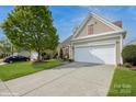 Charming home with a well-manicured lawn and two-car garage at 10314 Threatt Woods Dr, Charlotte, NC 28277