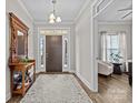 Welcoming entryway with hardwood floors, chandelier, and decorative console table with mirror at 1050 Coppergate Dr, Salisbury, NC 28147