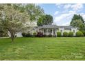Well-maintained single-story home with a lush front lawn and mature trees, offering great curb appeal at 106 S Oakwood Dr, Kings Mountain, NC 28086
