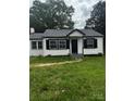 Charming white one-story home with black shutters and a newly replaced roof at 1104 Linwood Rd, Gastonia, NC 28052