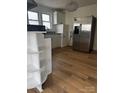 Updated kitchen with granite countertops, stainless steel refrigerator, and wood flooring at 1104 Linwood Rd, Gastonia, NC 28052