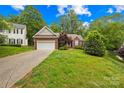 Charming brick home featuring a well-manicured lawn and attached two-car garage at 11732 Borchetta Dr, Charlotte, NC 28277