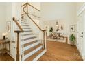 Inviting foyer with hardwood floors, staircase, and dining room, creating a warm and welcoming atmosphere at 12004 Willingdon Rd, Huntersville, NC 28078