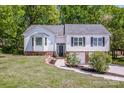 Charming two-story home with a manicured front lawn and brick accents at 142 Gray Barn Dr, Troutman, NC 28166