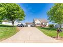 Picturesque home featuring a long driveway, attached garage, and lush green trees, providing a serene setting at 1556 Berkshire Dr, Newton, NC 28658