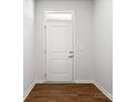 Clean entryway with a white door, modern hardware, and wood floors at 1933 Tin Roof Ln, Monroe, NC 28112
