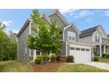This two-story home has stone accents and a well-manicured lawn at 1933 Tin Roof Ln, Monroe, NC 28112