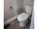 Close-up of a standard white toilet with a chrome toilet paper holder in a neutral-toned bathroom at 200 N Kayla Dr, Salisbury, NC 28146