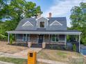 Charming two-story home with a inviting covered front porch, brick accents, and landscaped yard at 217 S Green St, Wadesboro, NC 28170