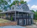 Charming two-story home with a inviting covered front porch, brick accents, and landscaped yard at 217 S Green St, Wadesboro, NC 28170