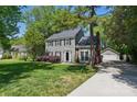 Two-story home with gray siding, black shutters, and a detached garage, providing ample parking and storage at 2224 Clonmel Pl, Charlotte, NC 28262