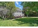 Beautiful two-story home with gray siding, black shutters, and a lush green lawn, offering classic suburban charm at 2224 Clonmel Pl, Charlotte, NC 28262