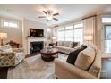 Inviting living room with a fireplace and plenty of natural light from large windows at 2306 Wesley Landing Rd, Waxhaw, NC 28173