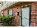 Close-up of a brick entryway with a white door, black mailbox, and tidy landscaping at 2332 Kenmore Ave, Charlotte, NC 28204