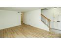 Bright, open living room featuring wood-look floors and staircase at 2332 Kenmore Ave, Charlotte, NC 28204
