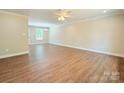 Spacious living room featuring hardwood floors, neutral walls, crown molding, and a ceiling fan at 288 Tram Rd, Lancaster, SC 29720