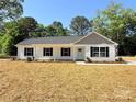 Well-maintained single story home with a welcoming front porch and freshly mulched landscaping at 296 Tram Rd, Lancaster, SC 29720