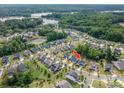Aerial view of a neighborhood with a lake and lush greenery, showcasing the property's location at 3017 Winged Teal Ct, Belmont, NC 28012