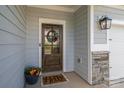 Close-up of a stylish front door with a decorative wreath and a welcoming 
